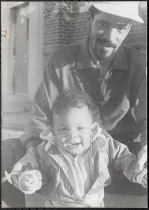 A man holding a baby in Newtowne Court