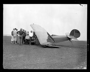 People gathered around wrecked airplane C5503