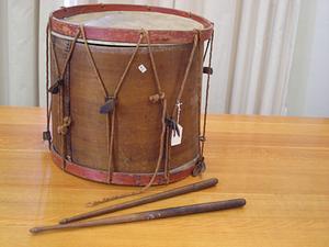 Drum with brown body and red rims