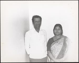 Couple posing against a wall