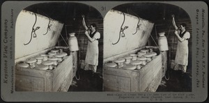 Cans of cream being put into vats of ice cold water