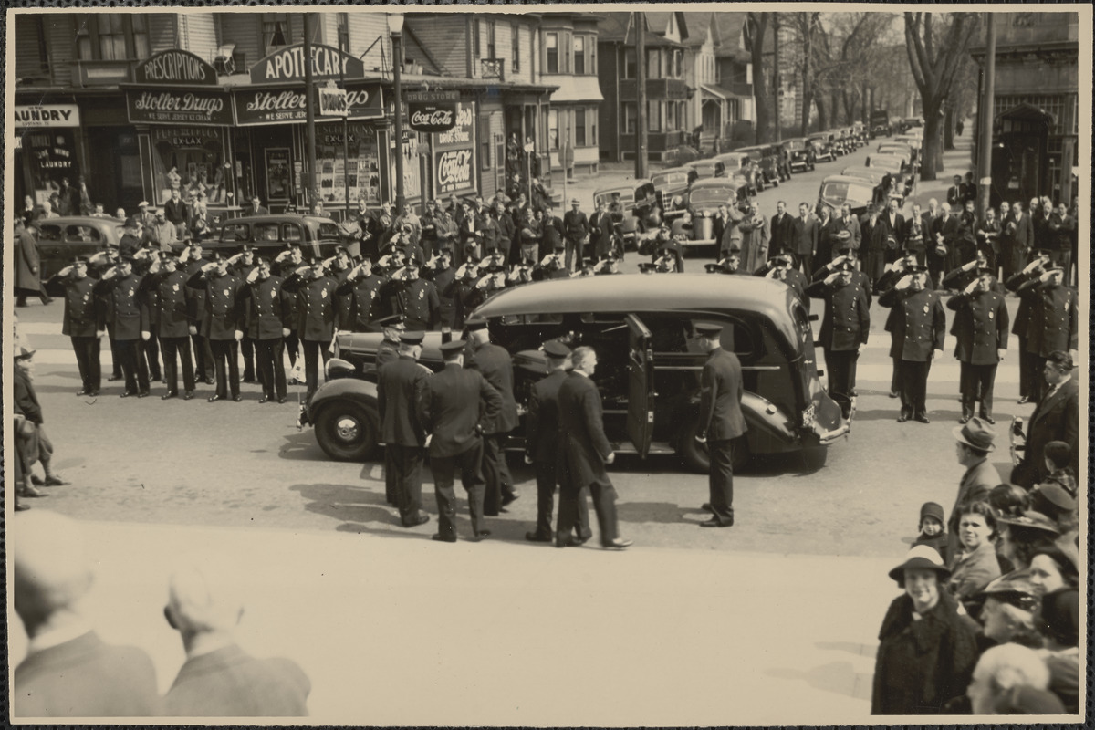 Platoon of police officers executing right hand salute as casket, containing body of former police Capt. Michael J. Brennan who died as a result of beating, was placed in hearse