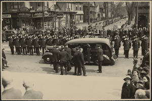 Platoon of police officers executing right hand salute as casket, containing body of former police Capt. Michael J. Brennan who died as a result of beating, was placed in hearse