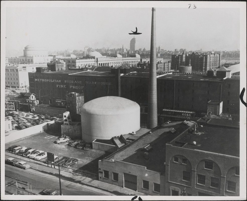 Aerial view of MIT nuclear reactor building (tank-like structure in picture above) and building to its right housing its laboratories, shots and offices