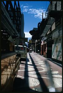 View down narrow street with signs including "Horse Race Betting," "Bank Cafe," and "Ohio," Reno, Nevada