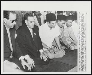 Prayer in Jakarta - Ferhat Abbas, second from left, premier of the Algerian rebel regime, kneels in prayer with Indonesian President Sukarno, third from left, and aides at new mosque in Jakarta. Abbas, who is on visit to Indonesia, joined Sukarno and other members of the Moslem is on visit to Indonesia, joined Sukarno and other members of the Moslem community in ceremony Friday.