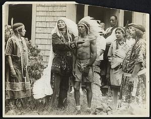 Chief Sunset is shown placing a string of beads on Chief Clearwater of the Narragaset tribe, who has just won the Marathon race for Indians at Mashpee.
