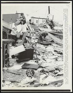 Plano, Tex: A family digs through the wreckage of their demolished trailer after a tornado struck the trailer park near Plano 4/27 injuring about 30 persons and damaging over 30 trailers. At least 13 persons are injured seriously. Damage is expected to run over $200,000. Weather.