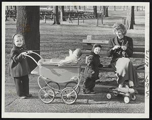 June in January-Typical scene on Bostoston Common today as sunny, spring-like weather was enjoyed by parents and children alike. Among those who took advantage were Mrs. Dorrit Stone and her two youngsters, Suzanne, 3, and Gregory, 2.