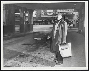 Wha Hoppen? An unidentified and disappointed commuter stands in the Haymarket Square terminal of the Eastern Massachusetts Street Railway Company waiting for a bus that never came.