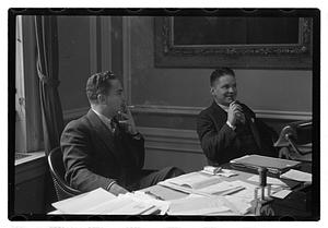 Two men seated at a desk