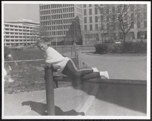 Girl balancing on parking barrier