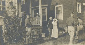 Soldiers and family members outside house
