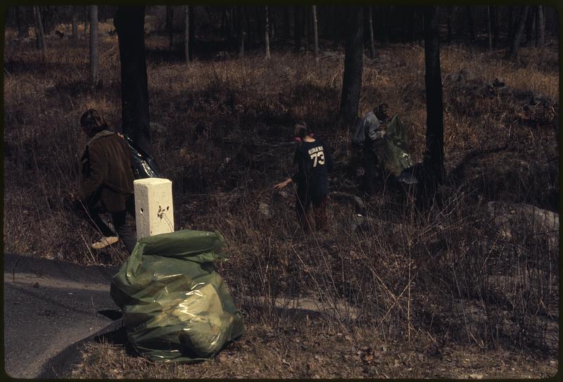 People picking up trash on the side of road