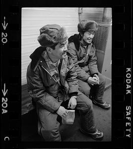 Two seated men in fur hats, North Slope camp, Anchorage, Alaska