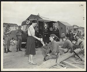 Red Cross Aids Tired Troops at the Curtis apartments, Worcester, where Shirley Goldell of the Boston Metropolitan Chapter, ARC, distributes milk to Pvt. Stanley J Collette of 122 Parker St., Gardner. He is a member of "G" Company, 181st Infantry Regiment.