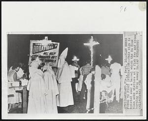 Klan Seeks Funds to Fight Integration--This sign is hoisted over a barrel which the Ku Klux Klan asks visitors at a fish fry and cross burning to drop money in.