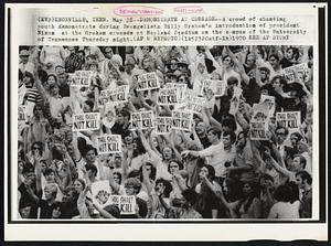 Demonstrate at Crusade--A crowd of chanting youth demonstrate during Evangelists Billy Graham's introduction of president Nixon at the Graham crusade at Neyland Stadium on the campus of the University of Tennessee Thursday night.