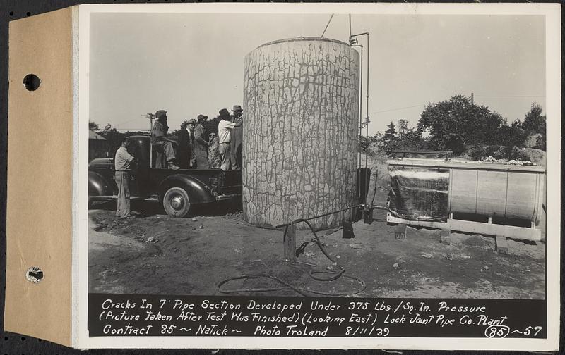 Contract No. 85, Manufacture and Delivery of Precast Concrete Steel Cylinder Pipe, Southborough, Framingham, Wayland, Natick, Weston, cracks in 7 foot pipe section developed under 375 lbs./sq. in. pressure, picture taken after test was finished, looking east, Natick, Mass., Aug. 11, 1939