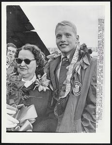 A crowd of 300 people greeted Olympic swimming star Don Schollander at Portland Monday, 11/2. He is shown here with his mother, Mrs. Schollander, of Lake Oswego, Ore.