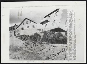 Aftermath of Swedish Landslide--Houses are lifted from their foundations and sidewalks are uprooted in Surte, Sweden following a giant landslide Friday which crushed some 40 houses and moved a railroad 100 yards. Police in Goeteborg, nine miles away, said only one person is known to have been killed. Surte is an industrial community of 2,000 inhabitants in western Sweden.