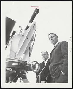 Using the Ruby Laser in the device above, Air Force Cambridge Research Laboratory scientists managed to bounce a beam off the Explorer 22 satellite and, for the first time, photograph the reflection. Robert Iliff, right, and Theodore Wirtanen, center, were testing the LARGO geodesy system at the time. The thin black tube is the laser and its cavity and the broad, black mass at far left is a photoelectric recorder. A stellar camera mounted in a telescope a few feet away photographed the light bounce.
