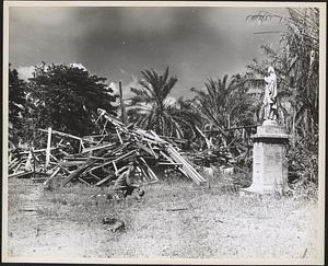A fighting marine kneels in reverence before a statue of the Virgin Mary at the Sacred Heart Mission, Visale Bay, Guadalcanal