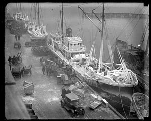 Ice covered trawler at pier