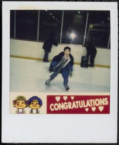 Boy ice skating in a rink