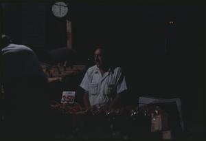 Man selling fruit or vegetables at market