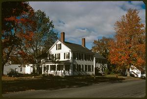 View of house surrounded by trees with autumn leaves