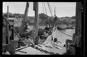 Rockport harbor, with a group of children and adults in a boat.