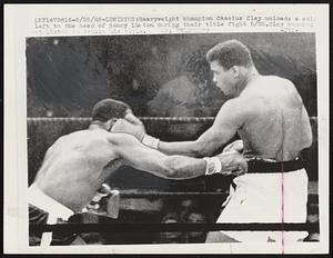Heavyweight champion Cassius Clay unloads a solid left to the head of Sonny Liston during their title fight 5/25. Clay knocked out Liston to retain his title.