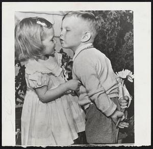 Spring’s Young Fancy – Three-year-old Herman (Speedy) McHorney gathered jonquils for his lady fair as the hot March sun drove reading to a record 81 at Norfolk, Va. But the ‘young’ swain had a proposition — “Give me a little kiss, Mary Lou (Kelley),” he teased, before giving up the bouquet.