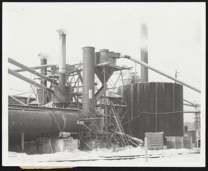 Putting the Heat on white pine lumber this largest bank of drying kilns in New England, at South Paris, Me., processes all parts of the logs for the Wilner Wood Products Co. Bark, sawdust, chips and strips formerly considered waste, all are used by the plant, as well as sound lumber for wedge heels.