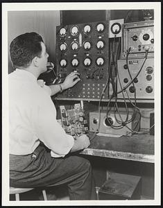 An electronic machine that saves up to 47 per cent of labor required for the testing of intricate Military equipment has been developed and built by Lewyt Manufacturing Corporation, Brooklyn. The machine is called the "Octopus." Here is one section of the machine, with a Lewyt engineer operating a test panel.
