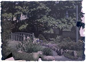 Garden with lamppost and small bridge