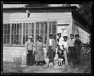 A group of people stand in front of a sign that reads "Gymnasium Privileges 25 cents"