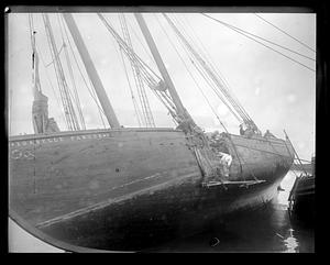 Men examining the "Isabelle Parker" which has a hole in its side