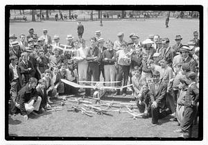 A group of boys behind a collection of model planes