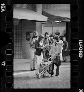 Market researcher interviews customers at shopping mall in Brighton