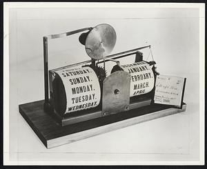 This gadget, if correct, gives you the day and month of the year, through an ingenious series of clock movements. This is among the collection of 500 original patent models now on display at the Jordan Marsh Company.