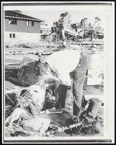 William F. Warren washs his face from a broken water pipe. After hurricane Camille hit this town there was no water or power.