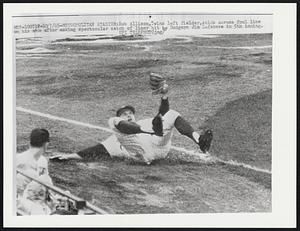 Metropolitan Stadium: Bob Allison, Twins left fielder, skids across foul line on his side after making spectacular catch of liner hit by Dodgers Jim Lefebvre in 5th inning.