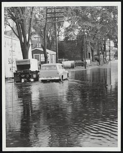 Running Tide - Bridge Street, Salem, is awash after sudden storm which pelted inland area as well as along the coast.
