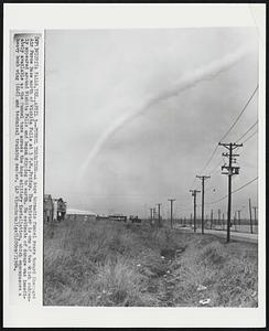 Funnel Threatens--A huge tornadic funnel roars toward Sheppard Air Force Base north of Wichita Falls at 3 P.M., Friday. The twister is one of two which suddenly appeared around Wichita Falls and began dipping to earth. No estimate of damage was immediately available as the funnel tore across the huge military installation, which encompasses a heavy bomb wing (SAC) and technical training center.