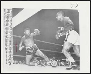 On the Way Down-- Heavyweight Champion Sonny Liston stands over a falling challenger Floyd Patterson in first round tonight at Las Vegas. It was second knockdown. Liston retained his title by knocking out Patterson in 2 minutes 10 seconds of the first round. Liston knocked Patterson down three times and Patterson stayed down the third time.