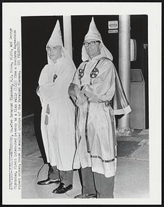 Two Savannah Klansmen, W.R. Moore, right and George Pigonnias, direct interested persons to a Klan rally (7/10) from a downtown Waynesboro street corner. Moore is exalted cyclops of the Savannah Klavern.
