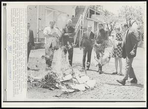 Burning Draft Records--Some of the nine persons arrested in Baltimore today look on as draft records burn after being set on fire by the group. The Rev. Philip F. Berrigan, 44-year-old-Catholic priest (third from left) is awaiting sentence in U.S. District Court for pouring blood from plastic bottles on draft records last Oct. 27. The group took the records from the draft board behind them and set them on fire in a parking lot nearby.