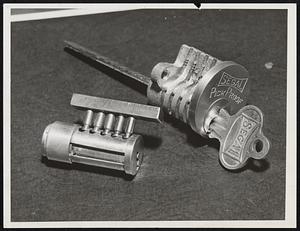 Pick Proof Lock. The new non-pickable cylinder lock invented by Samuel Segal, former detective of the New York Police Department, is seen. This lock can not be opened without the owner's key. The Segal pick-proof cylinder contains an oscillating protective sleeve fitted over the cylinder plug. The pin drivers are headed and undercut. When a lock pick is inserted in this cylinder, the pins, uncontrollable, trap and are locked by recesses in the protective sleeve.
